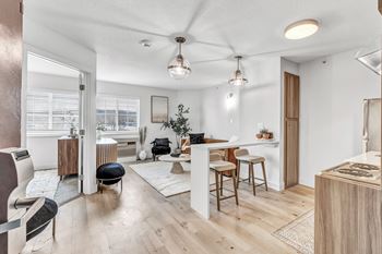 A living room with a kitchen and a dining room